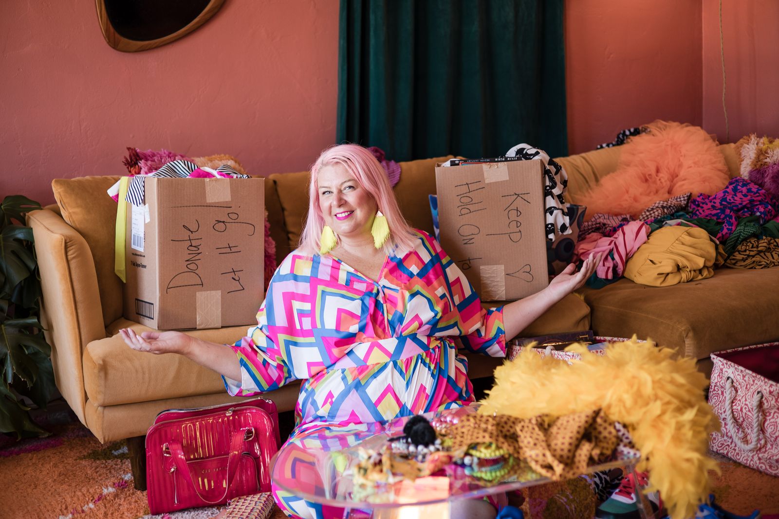 Unison Frances smiling on a sofa between boxes labeled Keep and Donate